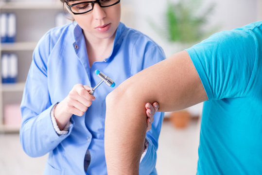 Doctor checking nerve reflexes with hammer