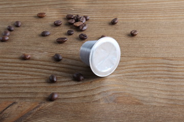 capsules of coffee on a wooden background