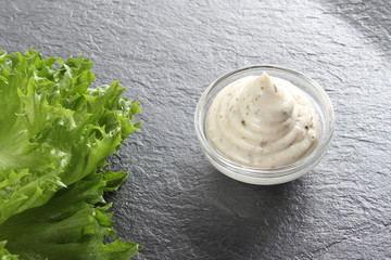 mayonnaise sauce, sour cream on a stone background