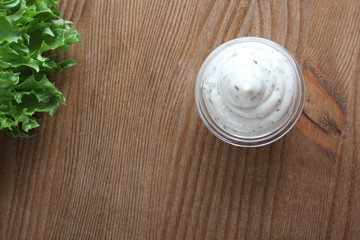 Fototapeta na wymiar mayonnaise sauce, sour cream on a wooden background
