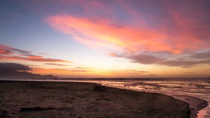 Purple sunset shot on the Kapiti coast beach near Paraparaumu in Wellington area, North Island of New Zealand.