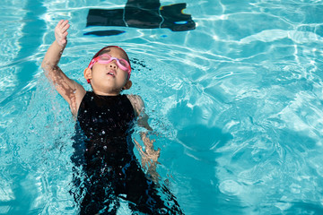 a girl learn how to swim in swimming class