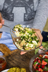 Vegetables salad with cucumbers, sauce, garlic, grated walnuts, parsley and green herbs. Served with tomato sauce. Raw vegan vegetarian food. Paleo diet