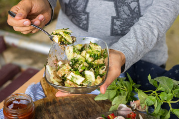 Vegetables salad with cucumbers, sauce, garlic, grated walnuts, parsley and green herbs. Served with tomato sauce. Raw vegan vegetarian food. Paleo diet