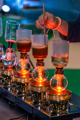 Siphon vacuum coffee maker and coffee grinder with drip brewing filtered coffee or pour-over is a method involves pouring hot water over roasted coffee beans contained in a filter old tradition