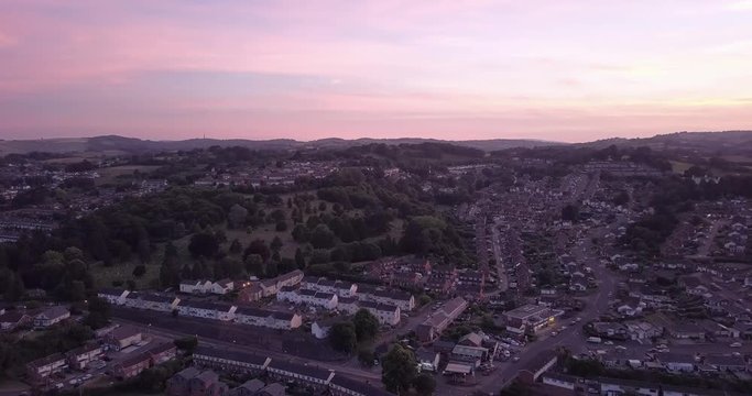 drone flies over a suburban neighborhood at sunset