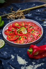 Asian tomato salad with soy sauce and red hot chilly pepper. Thai and Indonesian traditional food menu in cafe or restaurant. Raw vegan vegetarian healthy food. Paleo diet