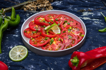 Asian tomato salad with soy sauce and red hot chilly pepper. Thai and Indonesian traditional food menu in cafe or restaurant. Raw vegan vegetarian healthy food. Paleo diet