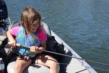 Little Girl Fishing off Boat