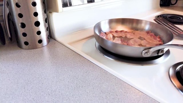 Panning shot of Bacon cooking (60fps)