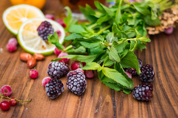 Ingredients for cocktail drink without sugar with honey, ginger, lemon (lime) and mint. Herbal Chinese tea with tropical fruits. Asian cafe refreshing drinks menu. Vegan vegetarian food and beverages
