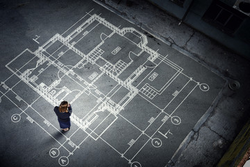 Woman engineer thinking over his plan. Mixed media