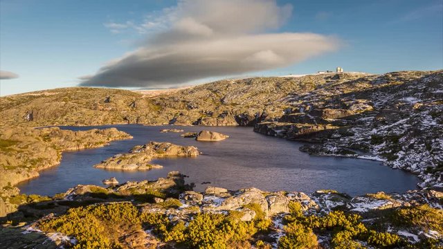 4k timelapse footage of Serrano Lake with a lenticular cloud moving over it, near the highest point of the Serra da Estrela Natural Park, Portugal.