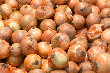 onions stacked on sale in supermarket