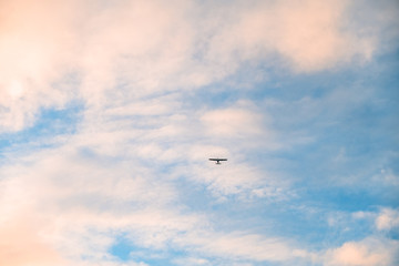 Airplane flying over the blue sky. cloudy and sunset.