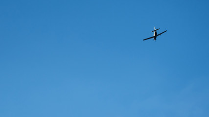 Propeller plane flying across blue sky