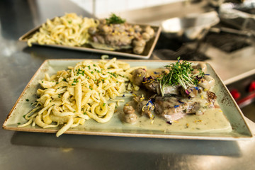 Spaetzle german baked gnocchi with chicken meat, champignons mushrooms asparagus and cheese