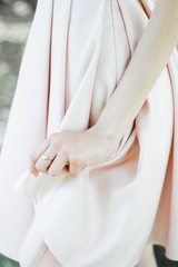 the bride is holding a wedding dress. Wedding details © dyageleva