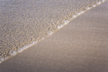 white sand and bright water wave