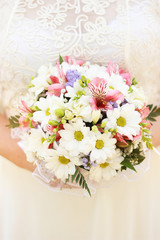Bouquet with flowers in the hands of the bride