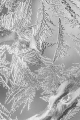 Frosty pattern at a winter window glass macro
