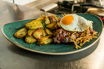 Tyrolean fried potatoes with meat bacon, mushrooms and a fried egg
