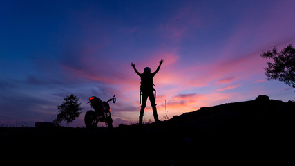 man and motorcycle in the sunset