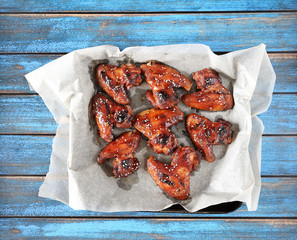 Barbecue grilled chicken wings  on a wooden background