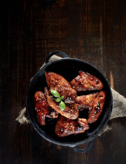 Barbecue on the grill chicken wings on a plate on a wooden background