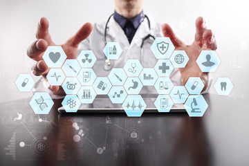 Medical doctor working with modern computer virtual screen interface. Medicine concept. EHR, Electronic Health Records.