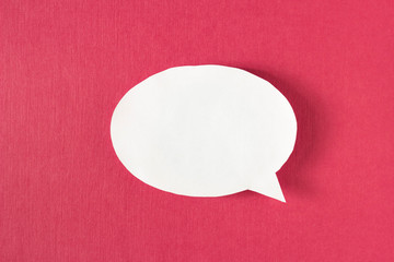 White bubble message from a paper on a red background, social network, symbol