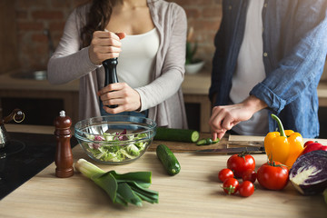 Closeup of couple cooking healthy food together