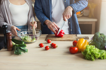 Closeup of couple cooking healthy food together