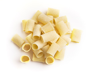 Pile of raw paccheri on white background