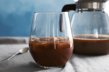 Glass with cold brew coffee on table