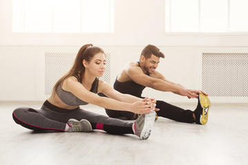 Fitness couple at stretching training indoors