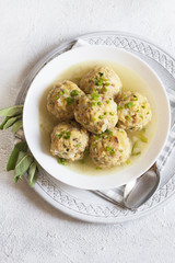 Homemade Canederli or Knödel in broth, typical for Alto Adige, German, Italian, Austrian cuisine.. Made from:stale bread, milk, eggs, bacon