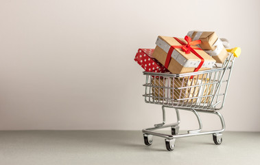 mini shopping cart with boxes with presents