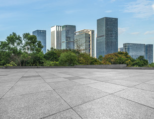 Empty wooden footpath front the city skyline