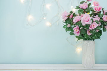 Sweet soft pastel pink korea style flower in white vase on wooden table decoration spakling light wall for valentine or anniversary important day with copy space for text or image.