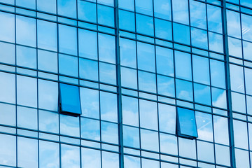 Fototapeta na wymiar Clouds Reflected in Windows of Modern Office Building.