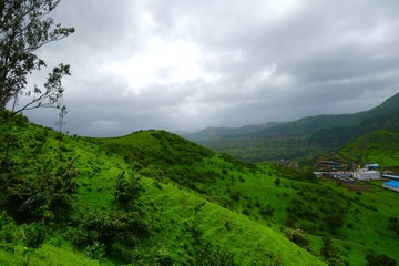 Green landscape surrounded by hills, mountains in monsoon season 
