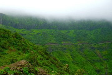 Green landscape surrounded by hills, mountains in monsoon season 