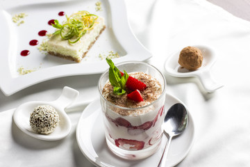 Sweet table with organic raw food desserts, sweets, yogurt with strawberries and lemon cake