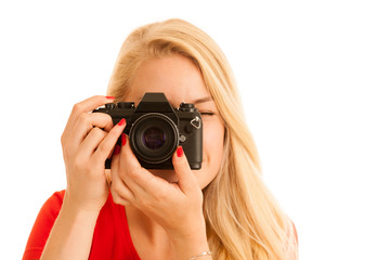 Woman in red with a retro camera isolated over white background