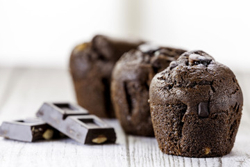 three chocolate cupcakes and piece