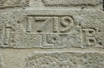 Old stone in the wall of the house, background