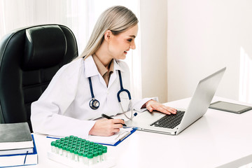 Doctor and stethoscope working with laptop computer in hospital.healthcare and medicine