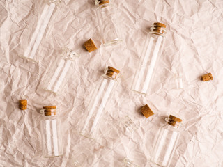 many small glass bottles used in medicine on paper background