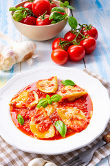 Delicious pasta - ravioli in tomato sauce with basil